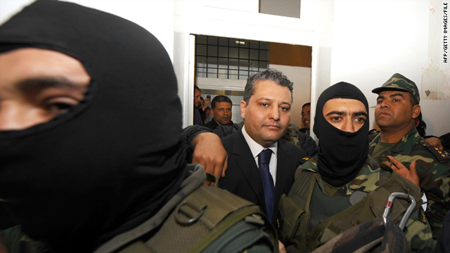 Imed Trabelsi, center, as seen on April 20 at the palace of justice in Tunis on arrival in court on drug charges.