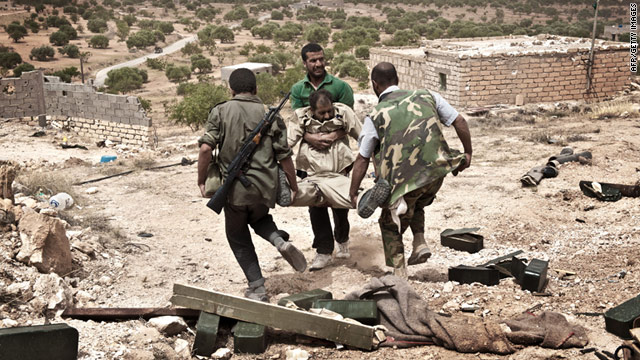 Libyan rebels carry away a comrade wounded during fighting with forces loyal to Libyan leader Moammar Gadhafi on June 7.