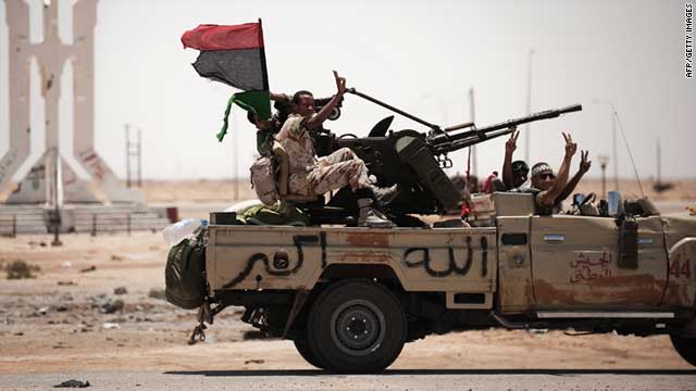 Libyan rebel fighters flash the victory sign as they drive on June 11, 2011 in Ajdabiya, south west of Benghazi.