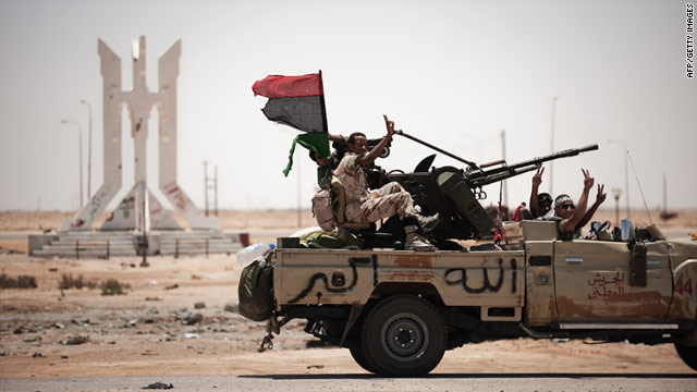 Libyan rebel fighters flash the victory sign as they drive to the frontline on June 11.