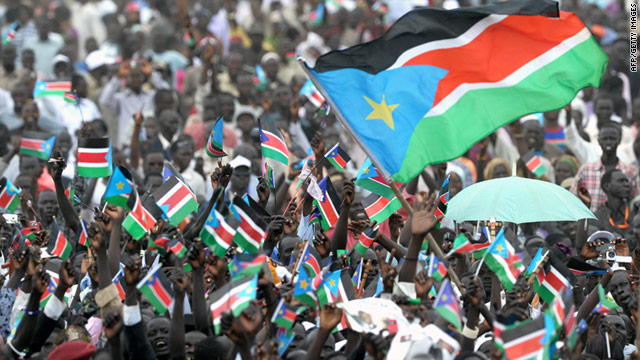 Southern Sudanese wave the national flag of the world's newest country, South Sudan, on Saturday.