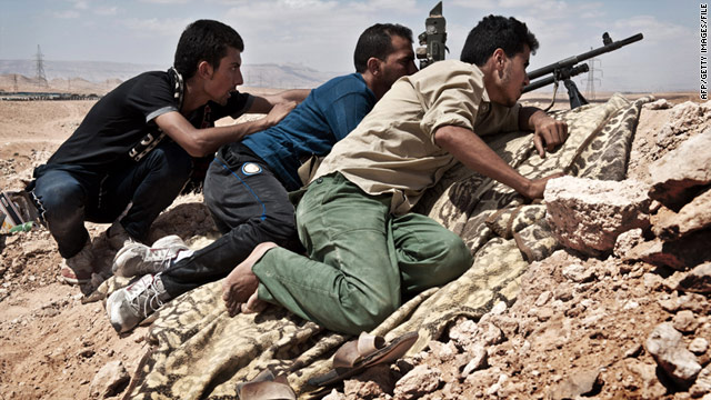 Libyan rebels look towards the front line near Bir Al-Ghanam in western Libya on June 26, 2011.