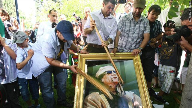 Demonstrators smash a portrait of Moammar Gadhafi during a protest outside the Libyan embassy in Turkey on August 22.