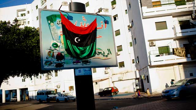 A Libyan rebel flag is hung across a billboard on August 25, 2011 in Tripoli.