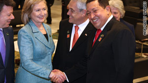 Secretary of State Hillary Clinton shakes hands with Venezuelan President Hugo Chavez on Saturday.