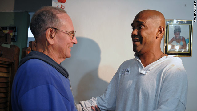 Recently freed Cuban dissidents Hector Maseda, left, and Angel Moya greet each other on February 12  in Havana, Cuba.