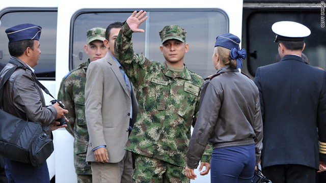 Former FARC hostage Henry Lopez waves at a Bogota military airport after his release on February 11.