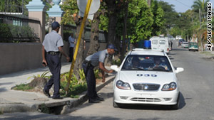 Cuban police patrol outside the municipal court in Havana on March 4 during Alan Gross' trial.