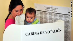A woman with her toddler votes Sunday in Lima, Peru.