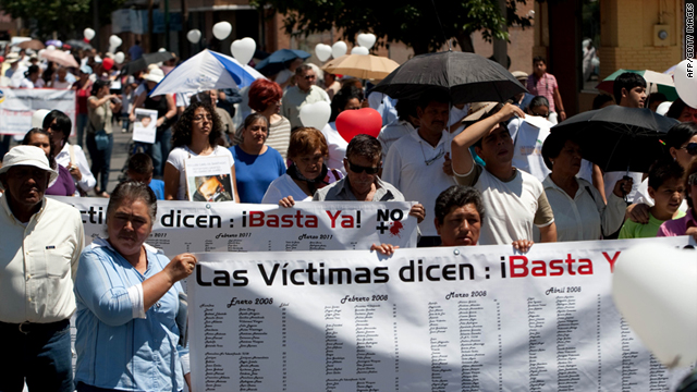 Demonstrators hold a banner reading "Victims say: Stop now!" in Ciudad Juarez, on May 7, 2011, to protest drug violence.