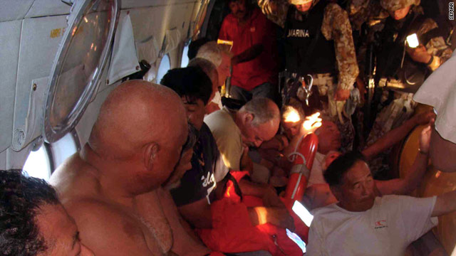Survivors from the capsizing of the Erik fishing boat fly on a helicopter to safety. Seven Americans are still missing.