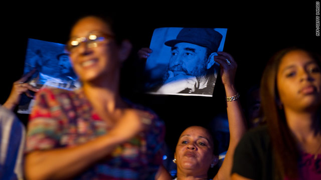 Cubans hold up pictures of former Cuban president Fidel Castro during a concert on August 13 at the Karl Marx theater in Havana.