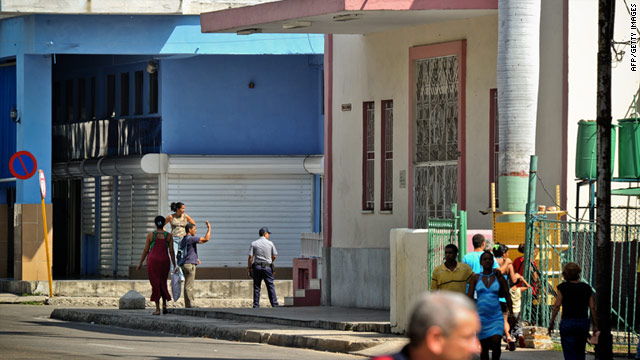 Cuban police keep a street closed near the church (R) where more than 60 believers remain in spiritual retreat in Havana.