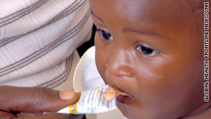 A Haitian child is given Nutributter, a supplementary food rich in nutrients.