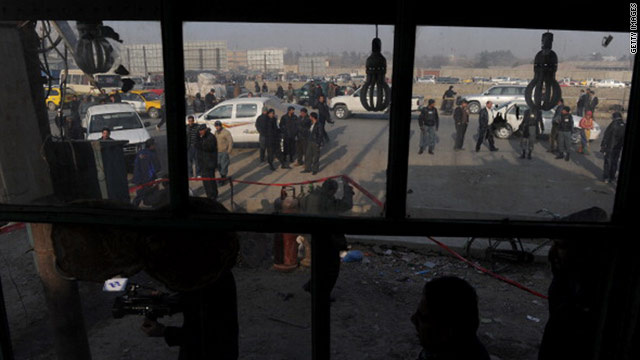 Afghan police officers investigate an explosion in Kabul on Tuesday.