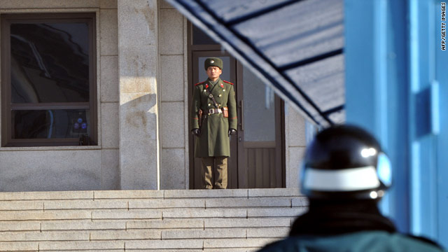 A North Korean soldier (C) and a South Korean soldier (R) stand guard in the Demilitarized Zone on Wednesday.