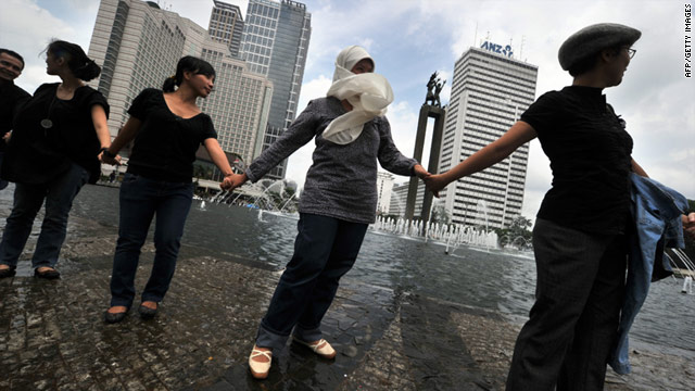 Indonesians hold hands together in Jakarta on January 7 to condemn the bloody religious clash which claimed three lives.