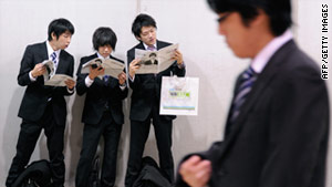 Students search for jobs from private companies and local governments at a job fair in Tokyo last month.