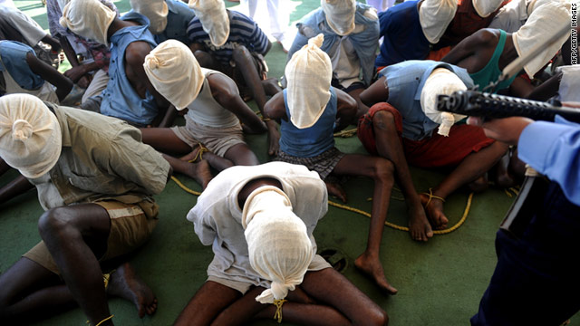 Suspected Somali pirates sit onboard an Indian coast guard ship off the coast of Mumbai on February 10.