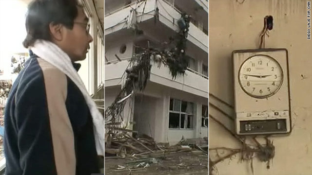 Atushi Asokawa goes through the wreckage of Togura Elementary School, smashed by Friday's tsunami. A school clock is frozen the moment the earthquake hit.