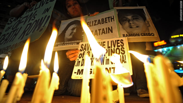 A protester lights a candle during a vigil appealing to the Chinese government to stop the execution of three Filipinos and commute their death sentences on humanitarian grounds in Quezon City, the Phlilippines, on March 24.