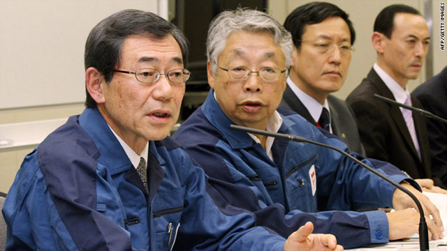 Tokyo Electric Power Company president Masataka Shimizu (left) speaks at a news conference in Tokyo on March 13, 2011.