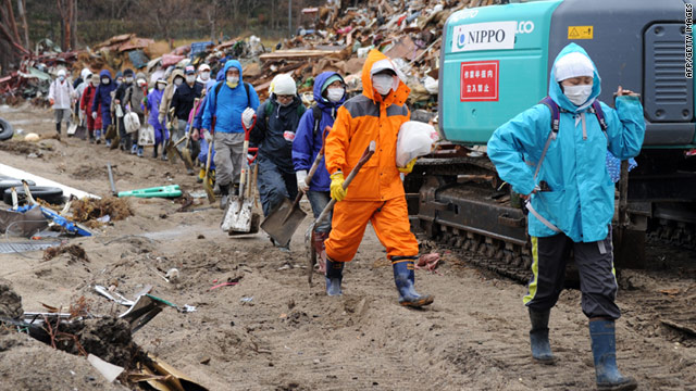 Volunteers arrive to clean up tsunami generated debris at the Whale and Ocean Science Museum in Yamada town, Iwate prefecture on April 16, 2011.