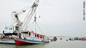 Rescue workers recover a passenger ferry which sank in Bangladesh.