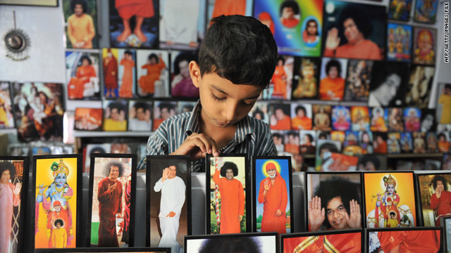 An Indian child looks at portraits of Spirtual Leader Sri Satya Sai Baba at a shop near Prashanthi Nilayam on April 6. One of India's best-known spiritual leaders, known for his apparent miracles and long list of influential followers, died on Sunday.
