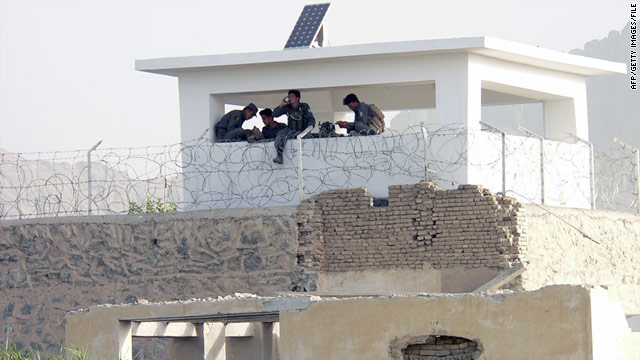 In this photograph taken on June 14, 2008, Afghan policemen sit in a guardhouse at the entrance to the main jail in Kandahar.