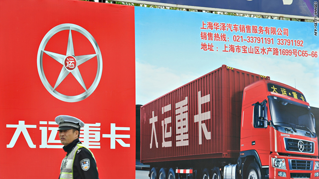 A Chinese policeman stands in front of a billboard of a truck at a port area of Shanghai amid strikes by drivers last week.