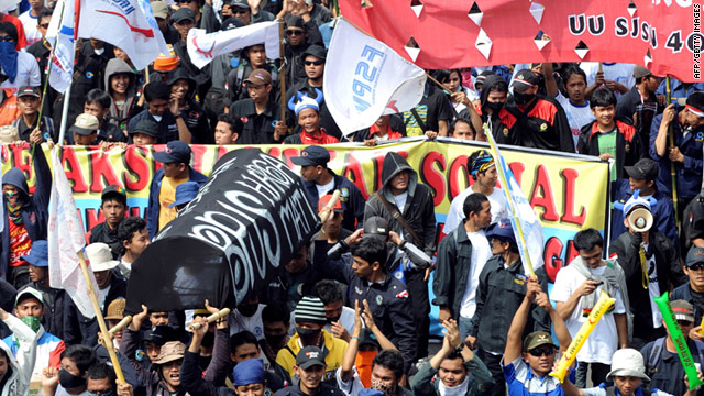 Labourers carry a fake coffin as they march towards the presidential palace during the May 1 rally in Jakarta.