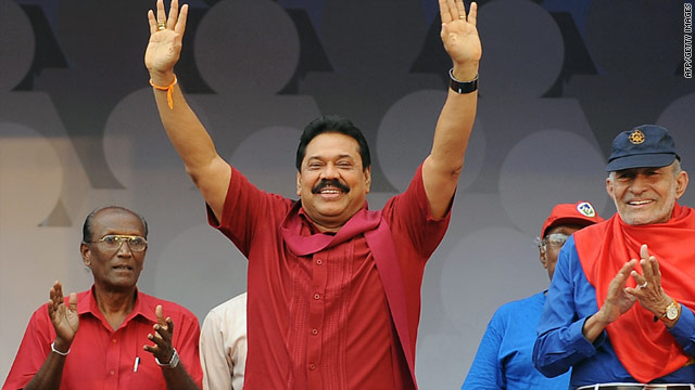 Sri Lankan President Mahinda Rajapaksa, center, waves during a rally in Colombo on Sunday.