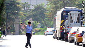 A policeman stops media from filming the Diaoyutai State Guesthouse for visiting dignitaries in Beijing Wednesday.