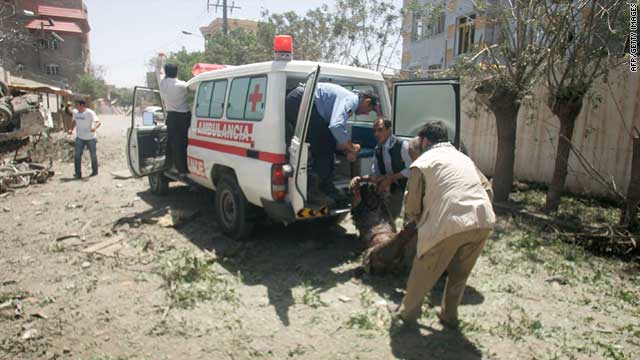 Afghan hospital workers carry a wounded man at the site of the attack in Herat, Afghanistan, on Monday.