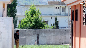 A Pakistani policeman guards bin Laden's former compound in May.