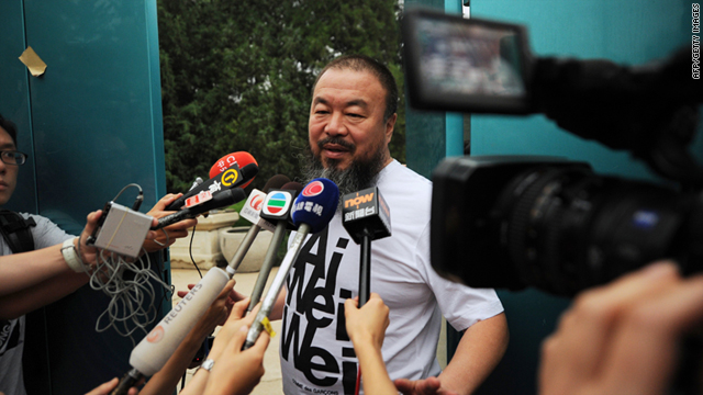 Outspoken Chinese artist Ai Weiwei speaks to reporters outside his studio in Beijing Thursday.
