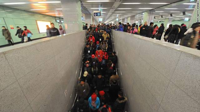 Passengers exit a subway station in Beijing in December 2010. One person was killed in an escalator accident Tuesday.