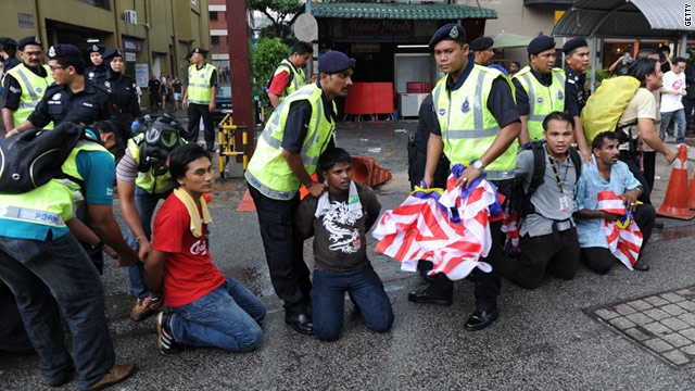 Malaysian police handcuff protesters at a mass rally calling for electoral reform in Kuala Lumpur on July 9.