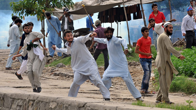 Activists throw stones at police during a march toward the U.S. Embassy in Islamabad on Friday.