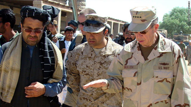 Staff Admiral Mike Mullen gestures as he speaks with Mohammad Gulab Mangal, left, in Marjah on March 30, 2010.