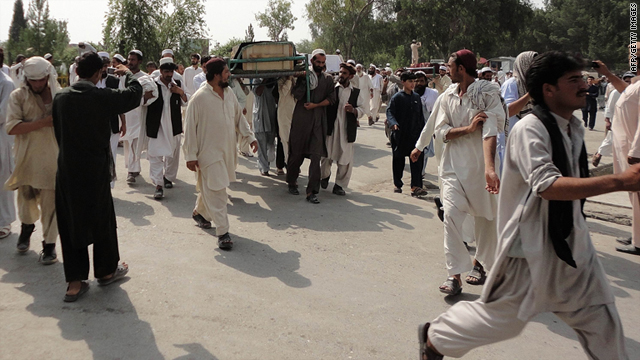Afghan men carry the bodies of those killed in a night raid in Khost province on Thursday.