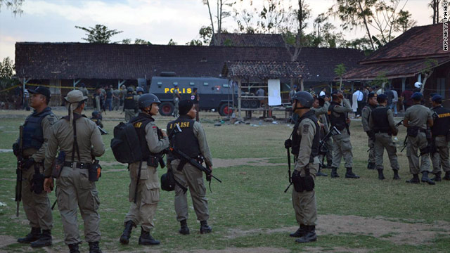 Indonesian policemen stand guard inside the Islamic boarding school's compound in Bima on July 13, 2011.