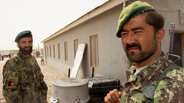 Two Afghan soldiers stand outside their barracks last week during a visit by U.S. Defense Secretary Leon Panetta.