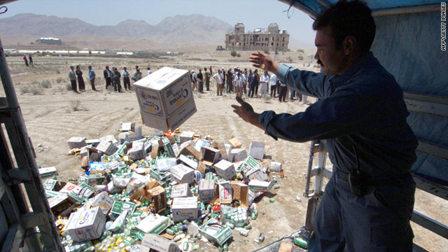 FILE: An Afghan policeman throws a box of beer out of a truck to be destroyed in Kabul, on July 17, 2006.