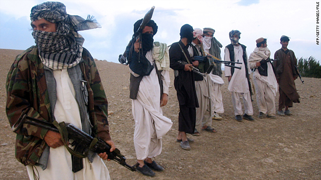 Fighters with Afghanistan's Taliban militia stand on a hillside at Maydan Shahr in Wardak province, west of Kabul.