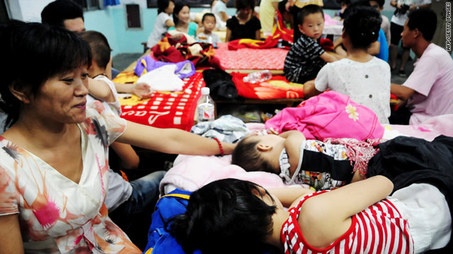 Chinese residents spend a night at a school in China's Shandong province on August 8, 2011.