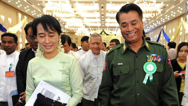 Aung San Suu Kyi talks with Border Affairs Minister, Major General Thein Htay on August 20, 2011.