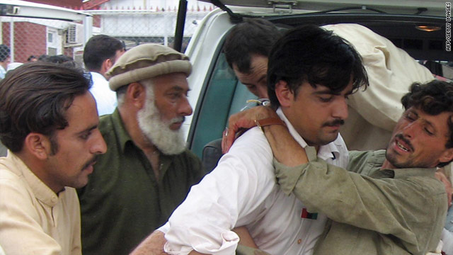 An injured bomb blast victim is carried to a stretcher after his arrival at a hospital in Tamir Graon.