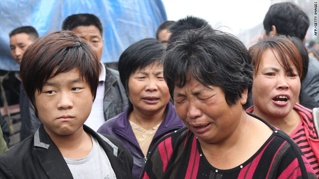 A woman grieves as family members of victims gather after a 30-year-old attacker killed six people with an axe in Henan province's Gongyi city on September 14.